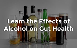 effects of alcohol on gut health overlay text with alcoholic beverages in background